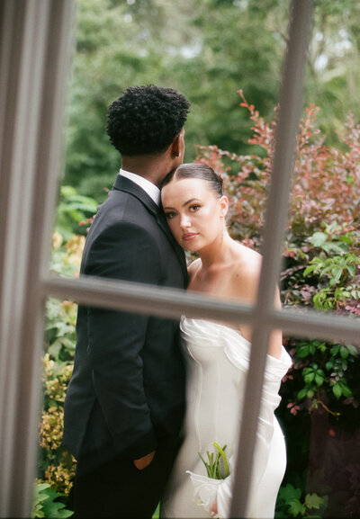 Bride and groom exchanging vows in a historic Charleston garden wedding venue surrounded by oak trees and Spanish moss