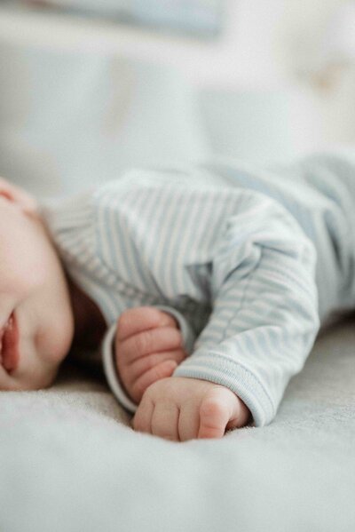 a detail shot of a newborn's hands during a lifestyle newborn session with pittsburgh luxury photographer kristin wieskamp