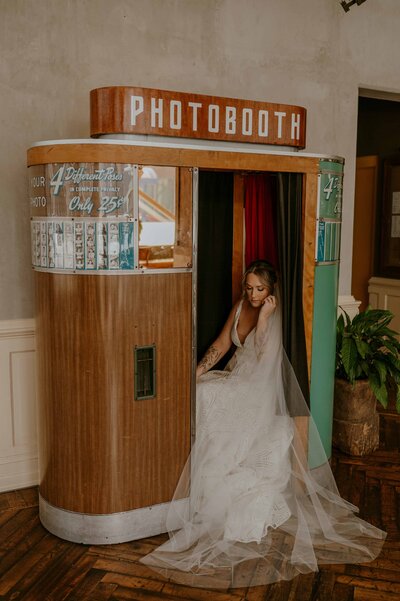 Bride sitting in photo booth in boho wedding in downtown Portland