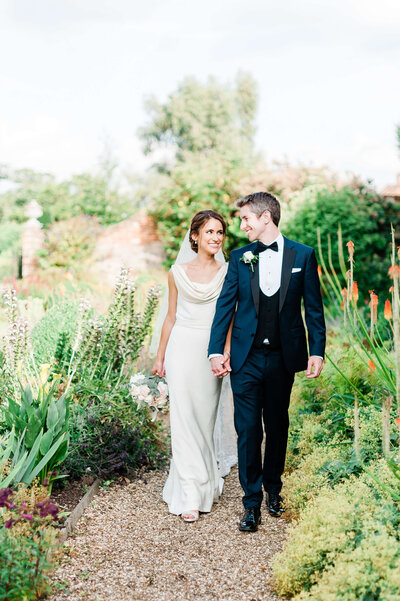 front page of rock my wedding publication featuring a wedding planned by westacott weddings and events and showing a bride and groom walking in a garden
