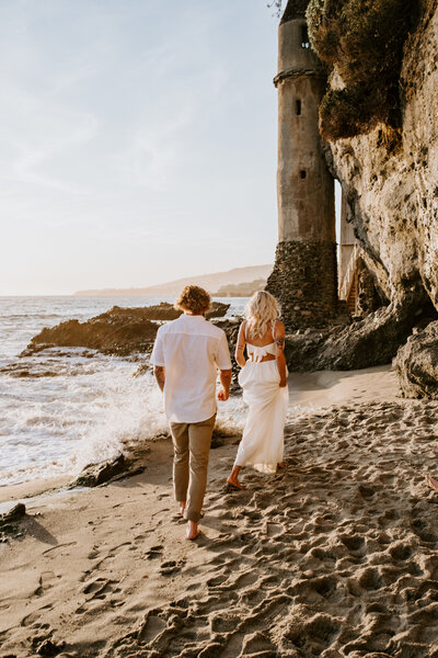 bride and groom walking on beach