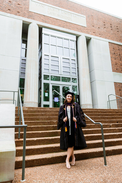 Senior wearing Master's grad attire on the Vanderbilt Law school front steps