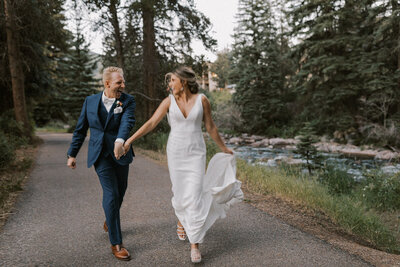 bride and groom walking down paved path together