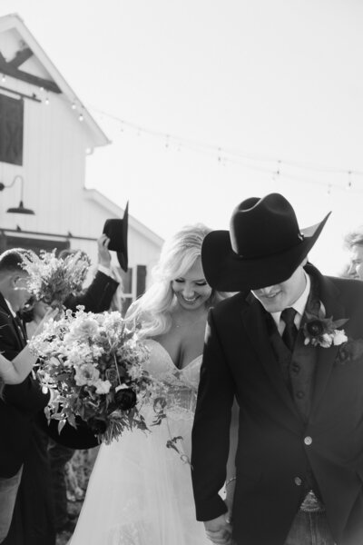 black and white image bride and groom kissing