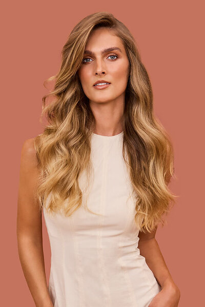 Long, honey blonde hair styled with Great Lengths extensions, showcasing natural blending and volume.
