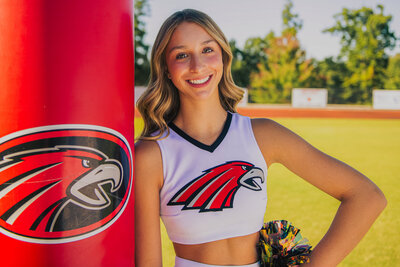 a high school cheerleader poses on a football field in Signal Mountain, TN
