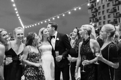 Guests at East Coast destination wedding captured under bistro lights by wedding photographers. 