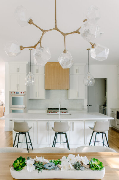 Dining and kitechen area of a newly constructed home featuring a large modern chandelier