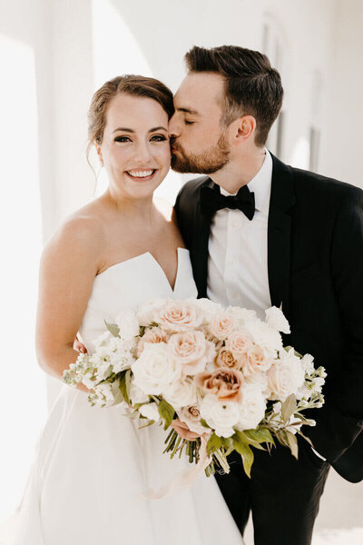 Groom kissing bride at wedding planneed by wedding planners in chicago