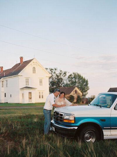 Wedding couple standing by their car at their outdoor wedding venue in Maine