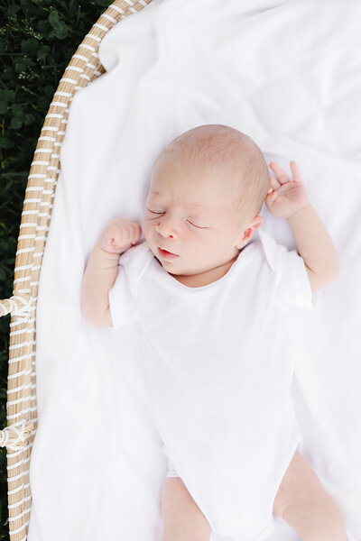 Newborn baby in the NICU holing mothers finger