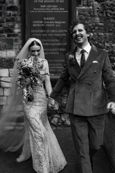 Wedding photographer captures couple taking a stroll hand in hand at their french chateau wedding.