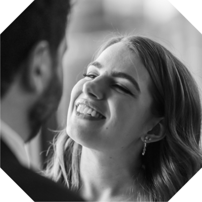 Grinning bride looks up at her groom - black and white wedding professional photo edit
