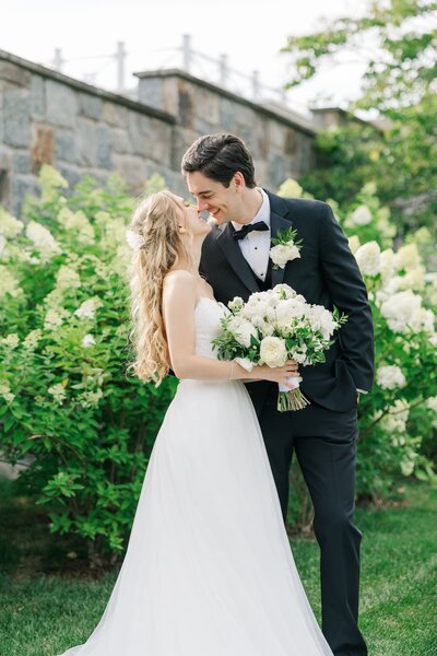 A bride and her bridesmaids smile and laugh with one another at John Joseph Inn before the bride gets married. 