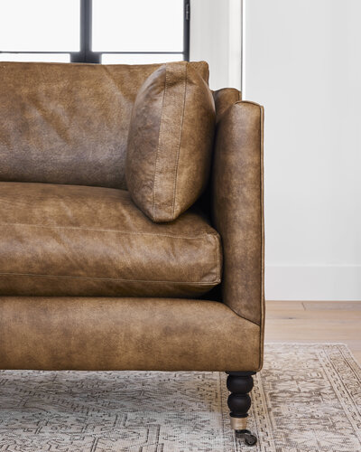 Add warmth and charm to your living room decor with our inviting and cozy sofa.