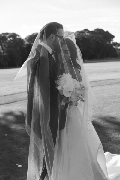 Newlyweds having an intimate moment for their portraits