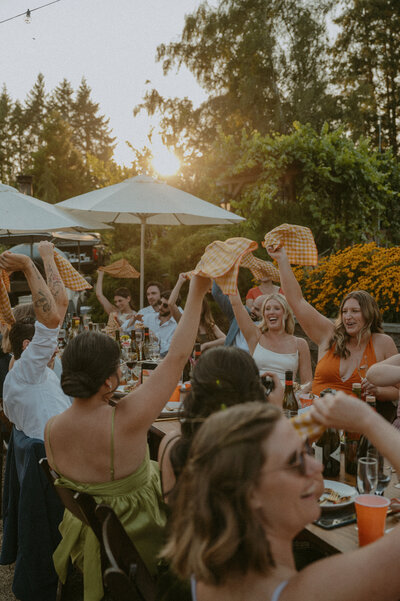 Waving napkins in the air during the reception to celebrate the marriage
