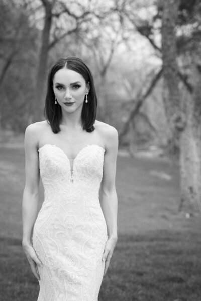 An Austin-based bride in a strapless wedding dress posing in a park.