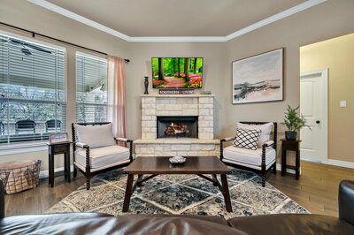 Fireplace in the living room of this three-bedroom, two-bathroom vacation rental lake house that sleeps eight just steps away from Stillhouse Hollow Lake in Belton, TX.