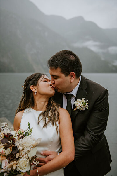 Couple kissing at thier beautiful adventure elopement with Coastal Weddings and Events at Chatterbox Falls B.C