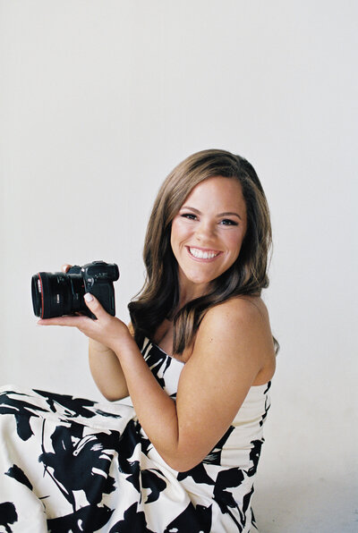 Photo of Claire Hodges Smiling with a camera