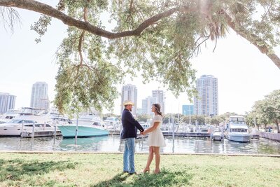 A beautiful elopement at Vinoy Park Marina View in St. Pete, featuring a picturesque waterfront backdrop and lush green lawns.