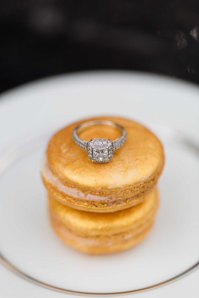 Gold Macaron's stacked with a diamond engagement ring perched on top