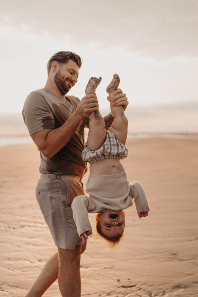 A pregnant women being photographed in Surrey fields on a summers day
