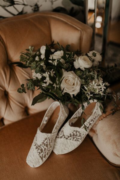 detail shot of bride's shoes and bouquet