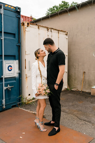 bride and groom standing face to face looking at each other