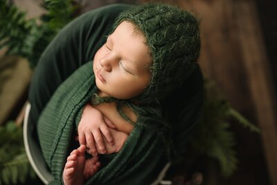 Baby boy in green posed in a newborn studio Harrisonburg, VA