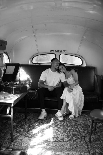 A bride and groom sitting on a couch in an Austin photo studio.
