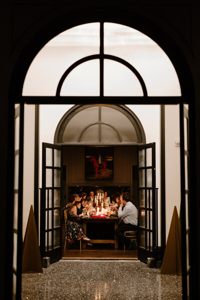 A wedding reception seen through open doors 