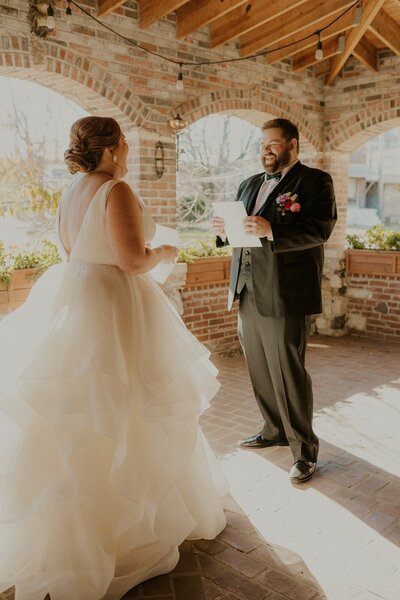 bride and groom reading their vows at grbic events in st. louis
