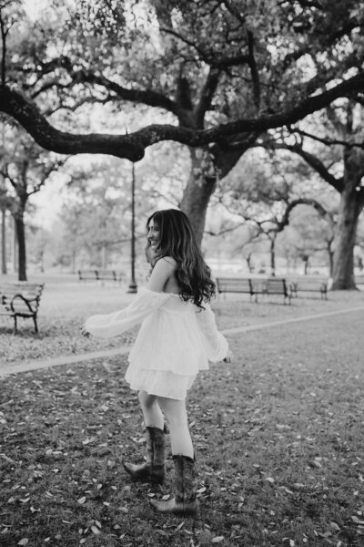 Female senior twirls during senior photoshoot
