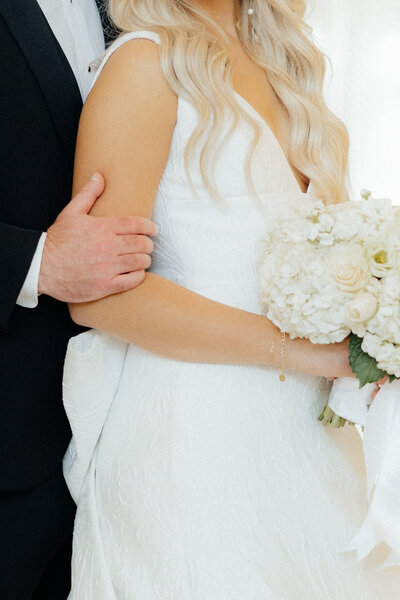 A bride holding her bouquet.