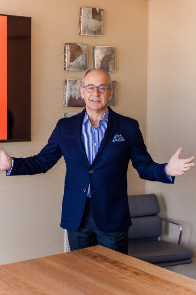 Ahmet Bozer making hand gestures while talking and looking at the camera during a conference room presentation in Atlanta Buckhead