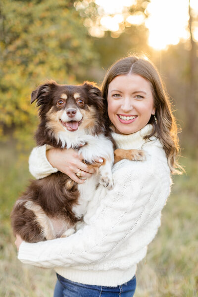 Mary Beth smiling with her dog, Marshall