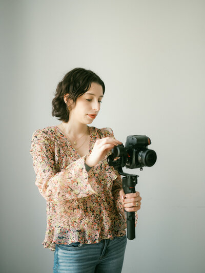 huntsville photographer holds camera and smiles