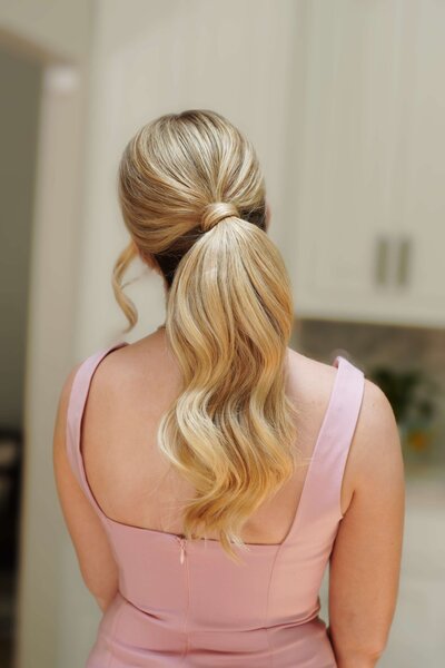 Polished high ponytail with clean lines and lift — sleek, modern bridal hairstyle by Klover Beauty in Maryland.