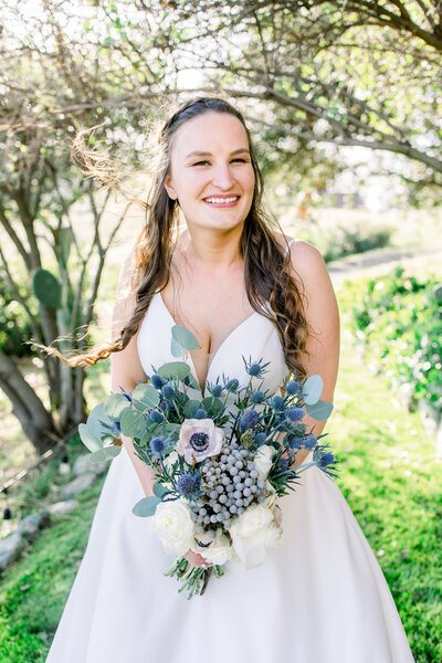 Bride shows off her bouquet at her wedding in San Luis Obispo