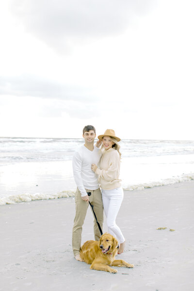 Husband and wife on the beach  with golden retriever | Jacksonville Wedding Photographer