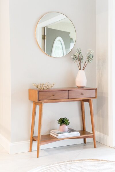 Modern tan circle mirror with brown hallway table