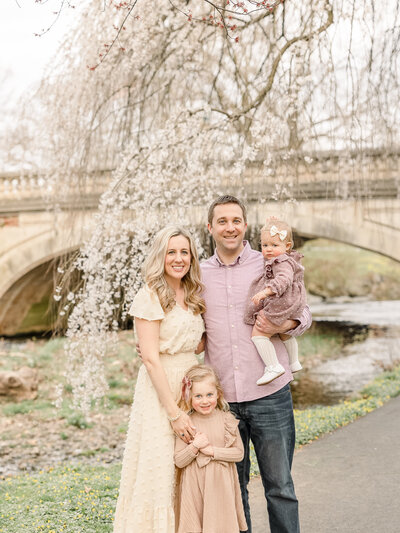 family in cherry blossom portrait session at park