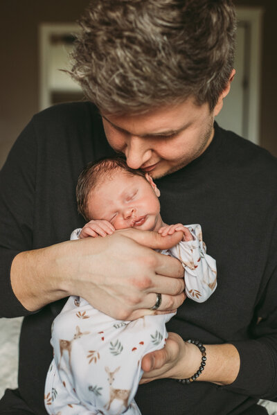 father holding newborn son