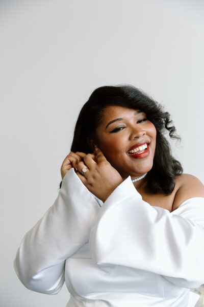 Bride holding up a bouquet of flowers during a beach elopement in Michigan.