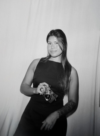 susan ly smiling in studio with camera