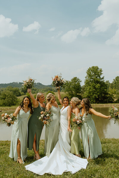 bride cheers with bridesmaids