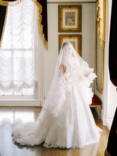 bride with luxury veil by window at the Julia Morgan Ballroom in San Francisco