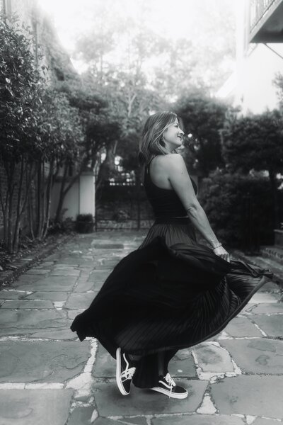 black and white photo of woman in black dress dancing